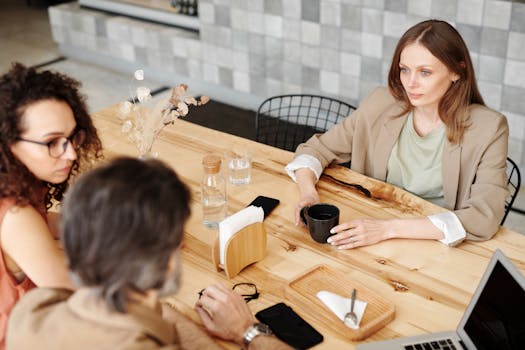 Colleagues having a team discussion at a contemporary café.