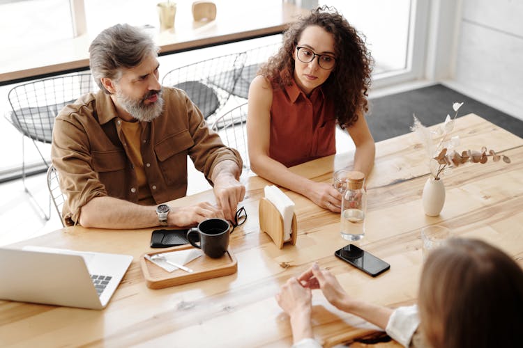 Women And A Man Having A Meeting