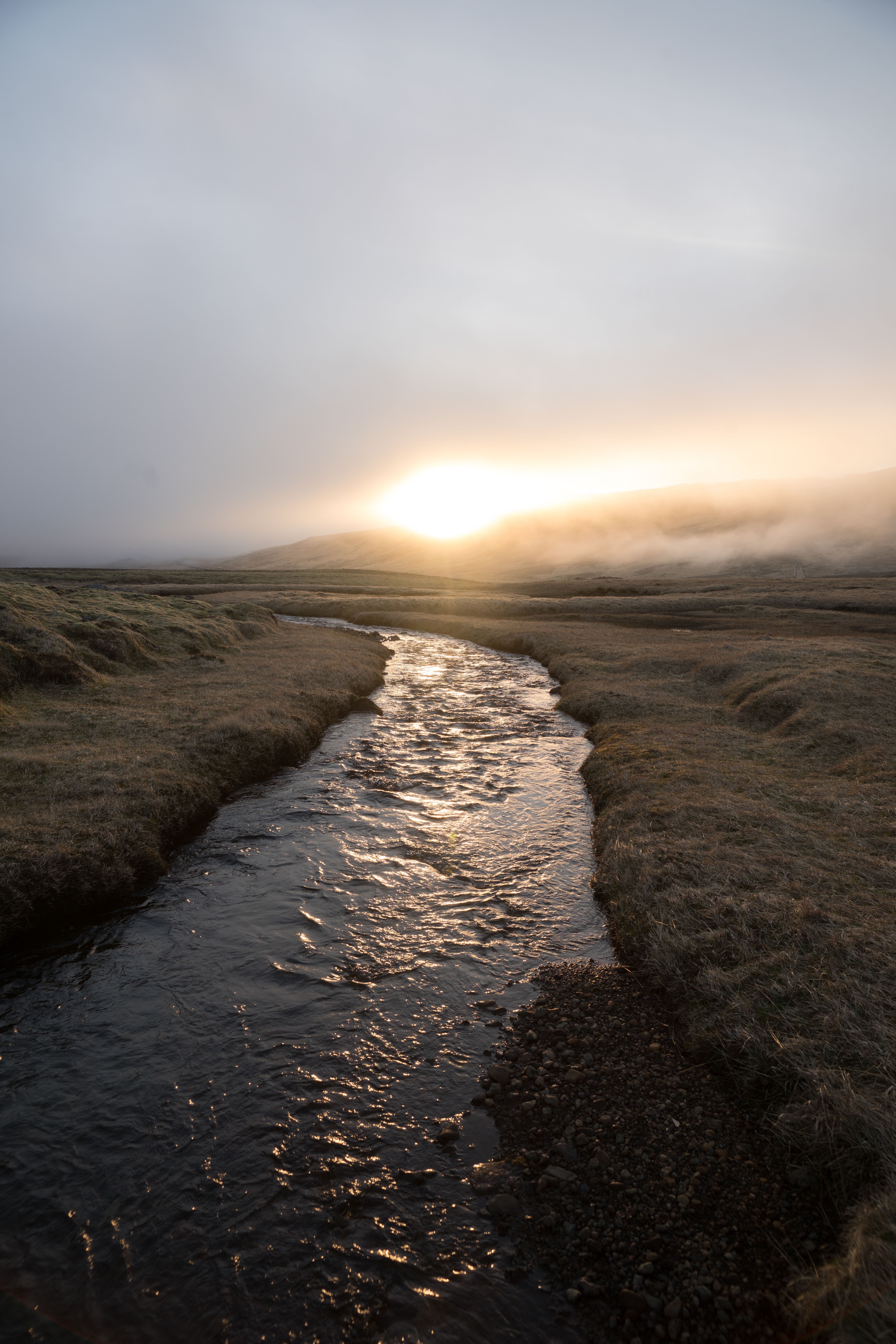 Lonely river in mountainous terrain during sundown · Free Stock Photo