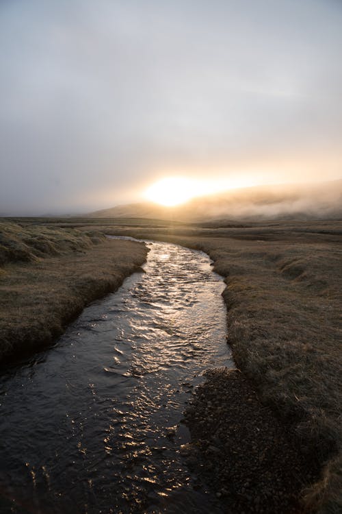 Free Lonely river in mountainous terrain during sundown Stock Photo