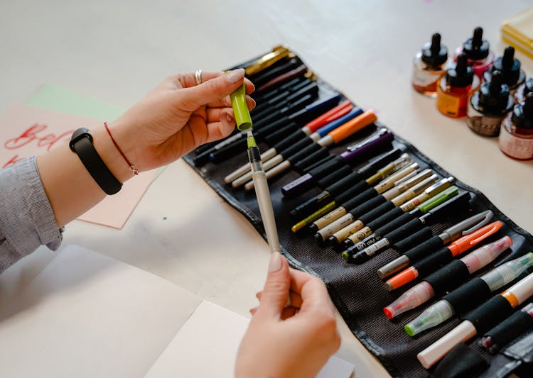 Person Holding Brush Pen