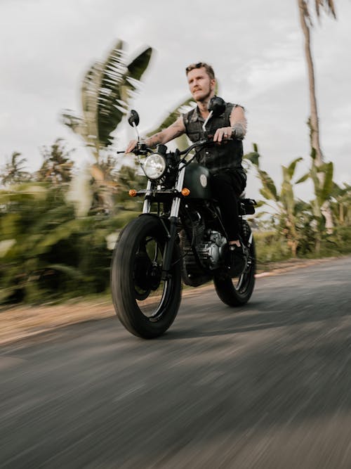 Man Riding Motorcycle on Road