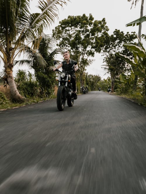 Free Man Riding Motorcycle on Road Stock Photo