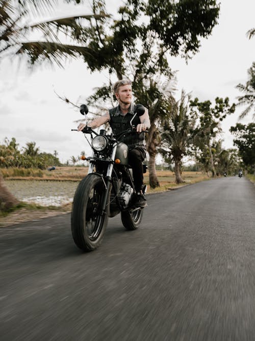 Photo of Man Riding Motorcycle on Road