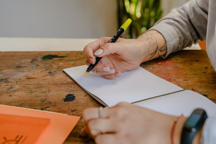 Crop Faceless Illustrator Sitting With Blank Album And Felt Pen