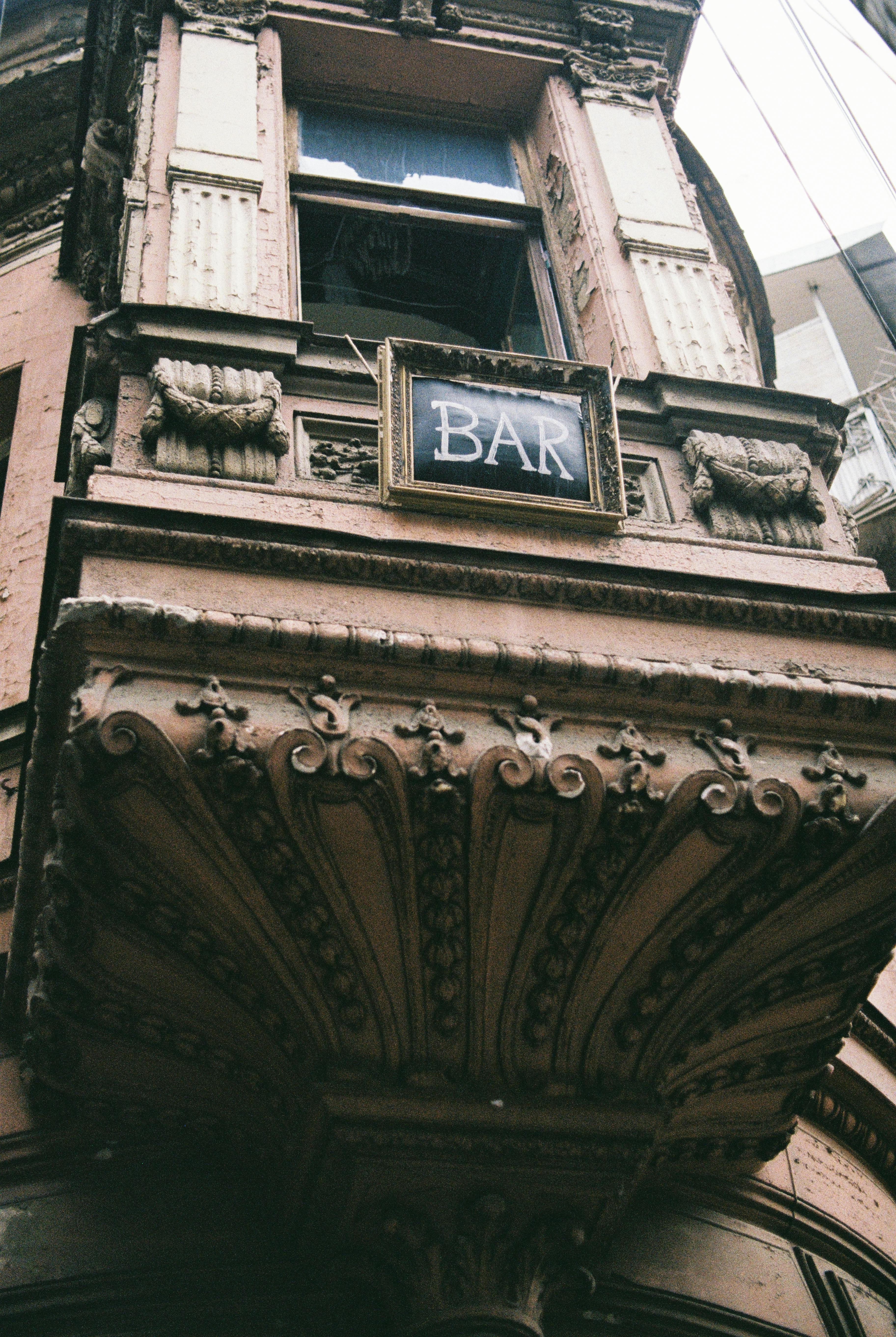 facade of old building with bar inscription in daylight
