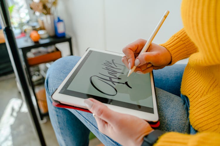 Person Holding White Tablet And Touch Pen