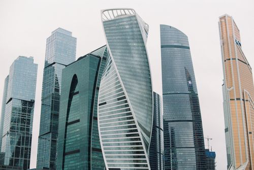 Free From below of contemporary skyscrapers in city street of megapolis in cloudy day Stock Photo