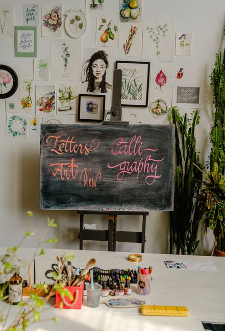 Chalkboard calligraphy in a creative studio surrounded by plants