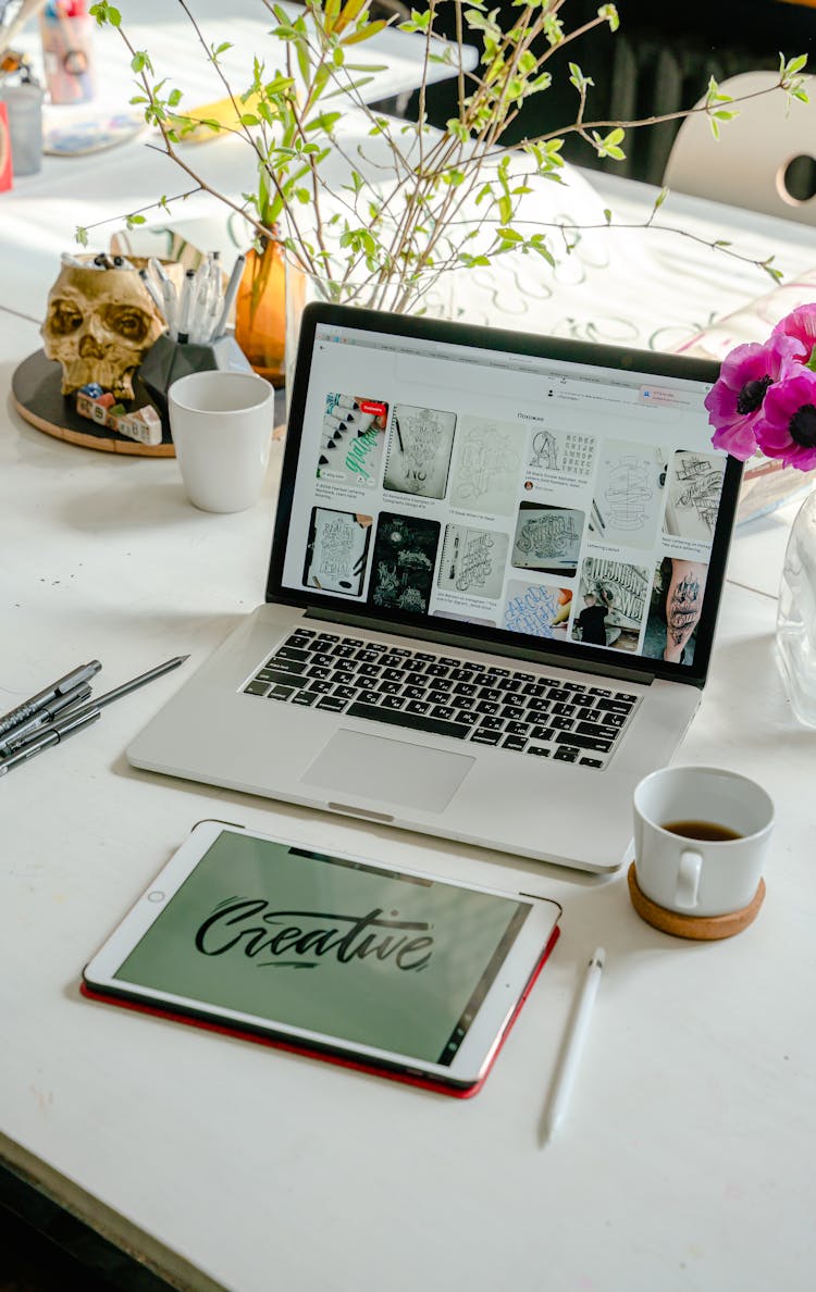 A Laptop And Tablet On The Table With Coffee On The Side