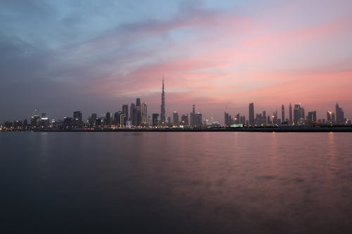 Free City Skyline Across Body of Water During Sunset Stock Photo