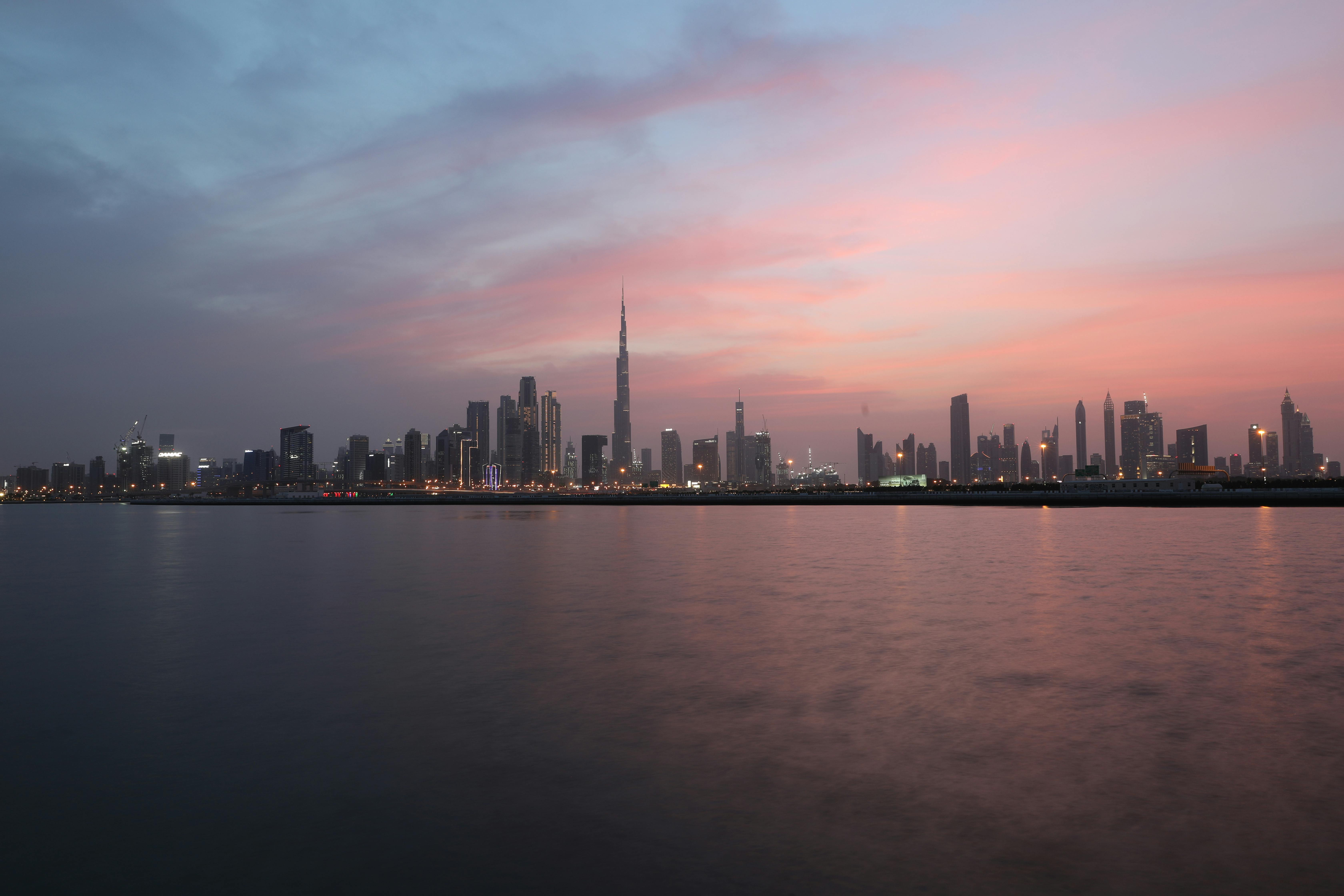 City Skyline Across Body of Water During Sunset · Free Stock Photo