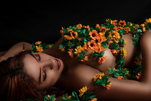 Sensual model with bright flowers on body