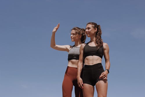 Beautiful Girls Standing Together Wearing Active Clothings 