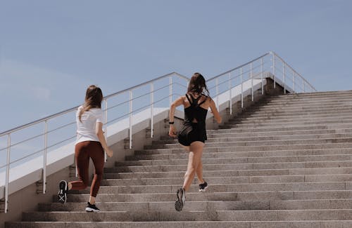 Free Women Running on Gray Concrete Stairs Stock Photo