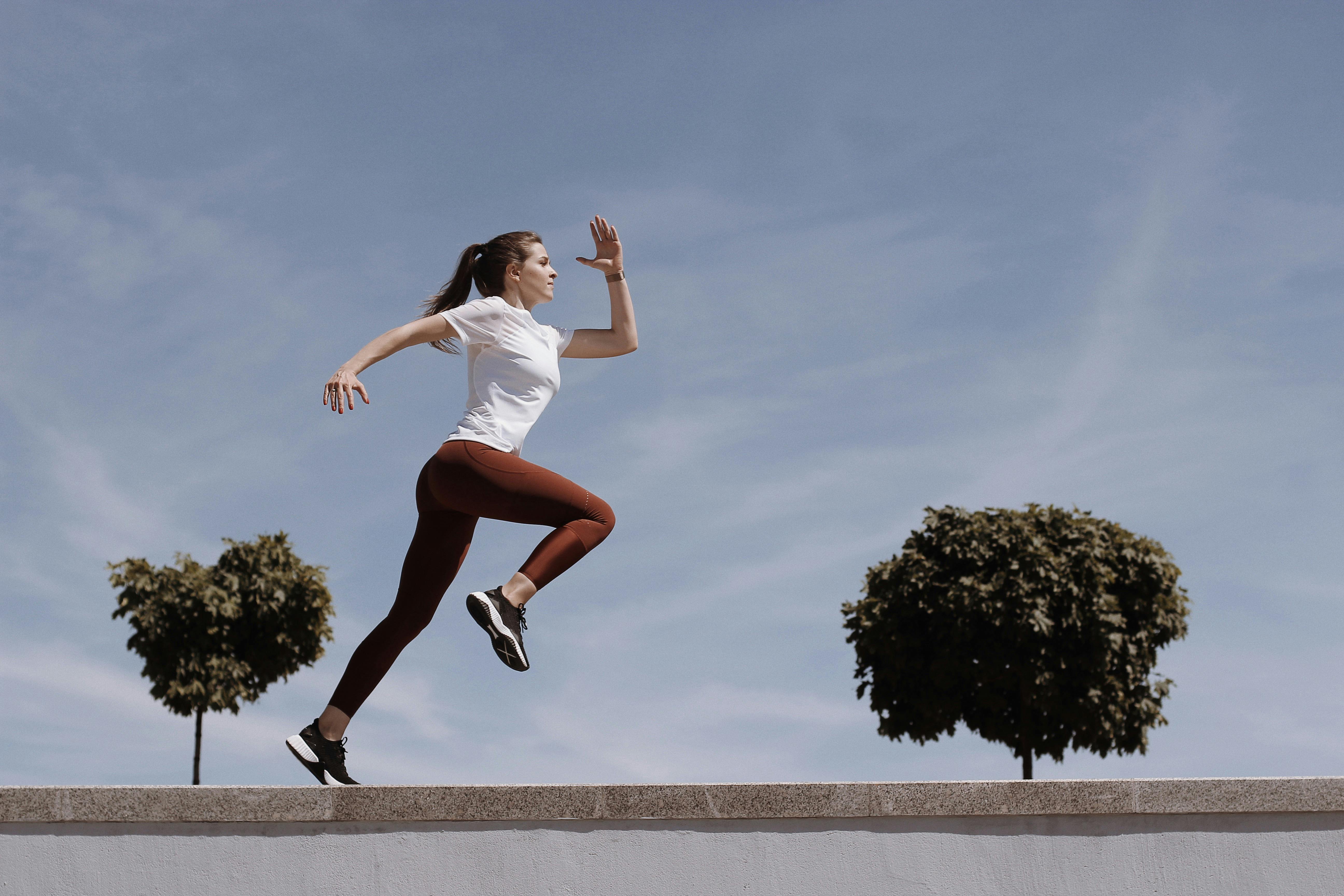 Woman in White Shirt and Leggings Running · Free Stock Photo