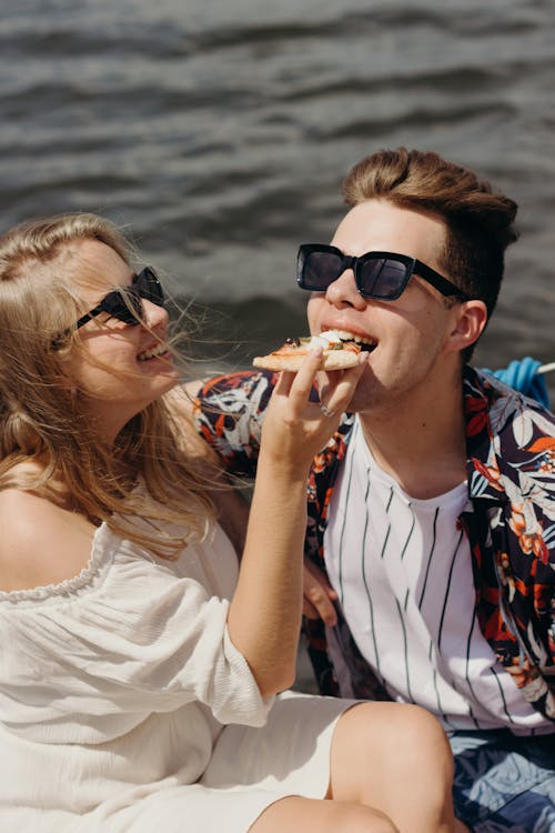 Free Couple Wearing Sunglasses Eating Pizza Stock Photo