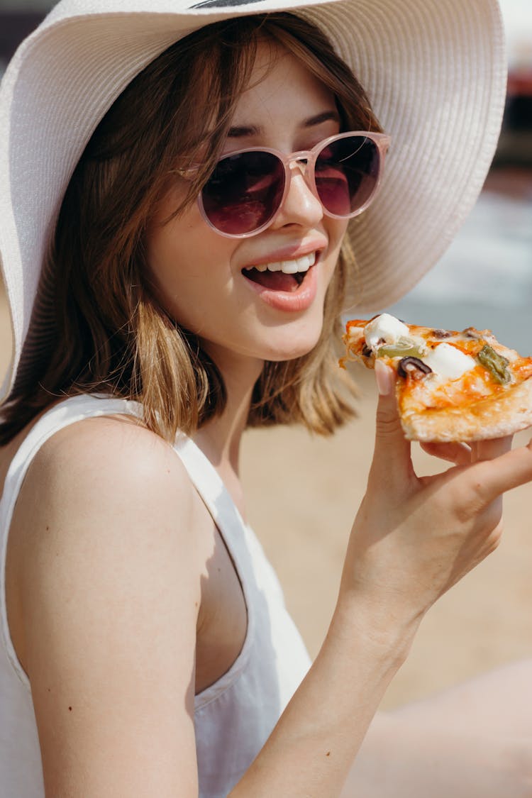 Woman In White Tank Top Holding Sliced Of Pizza