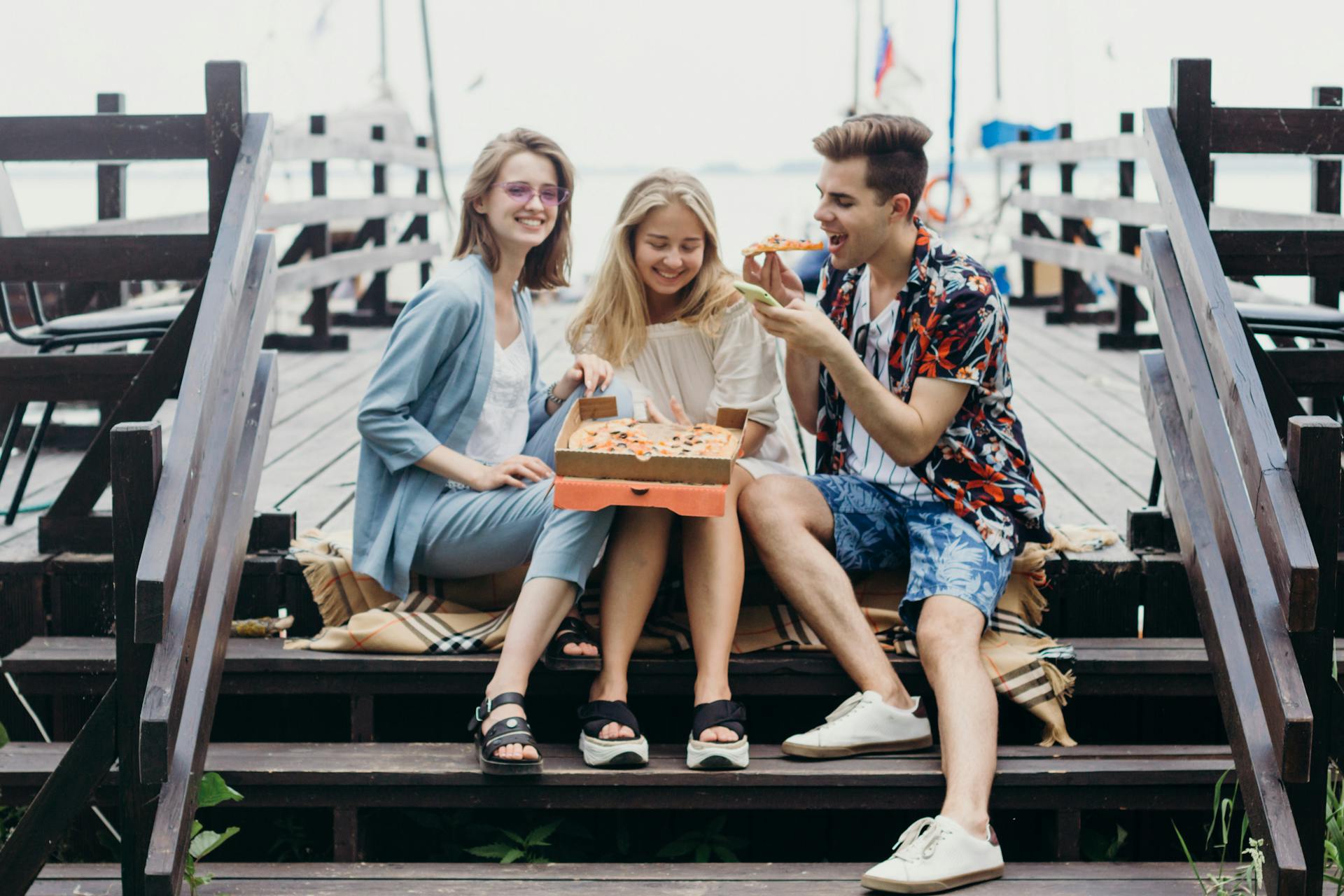 People Sitting on the Wooden Steps of Deck