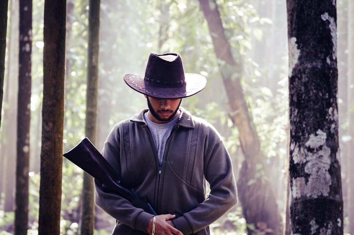 Free Portrait of Man in Cowboy Hat with Rifle Stock Photo