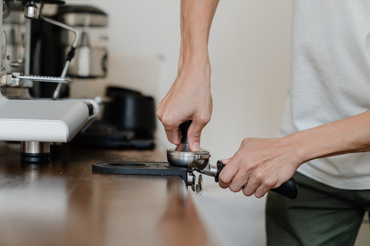 Crop Professional Barista Preparing Coffee At Wooden Counter