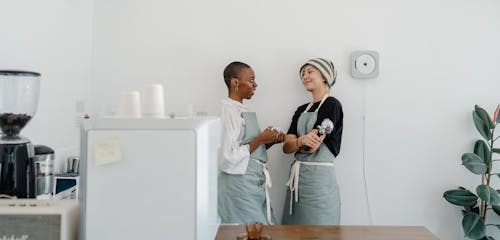 Free Friendly diverse couple of women communicating in coffee house Stock Photo