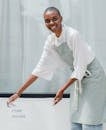 Happy black female worker setting signboard outside cafeteria