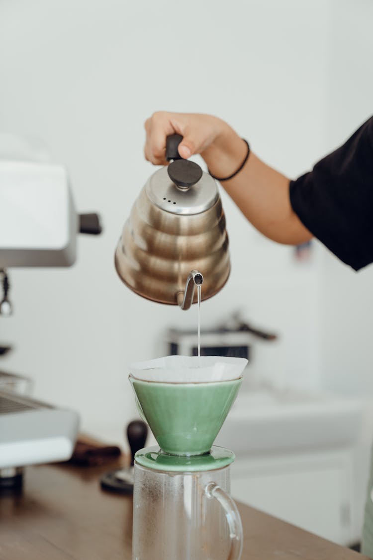 Crop Woman Preparing Hot Coffee In Kitchen