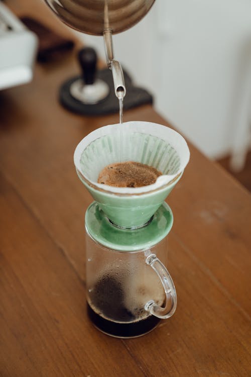 Coffee maker with coffee on wooden table