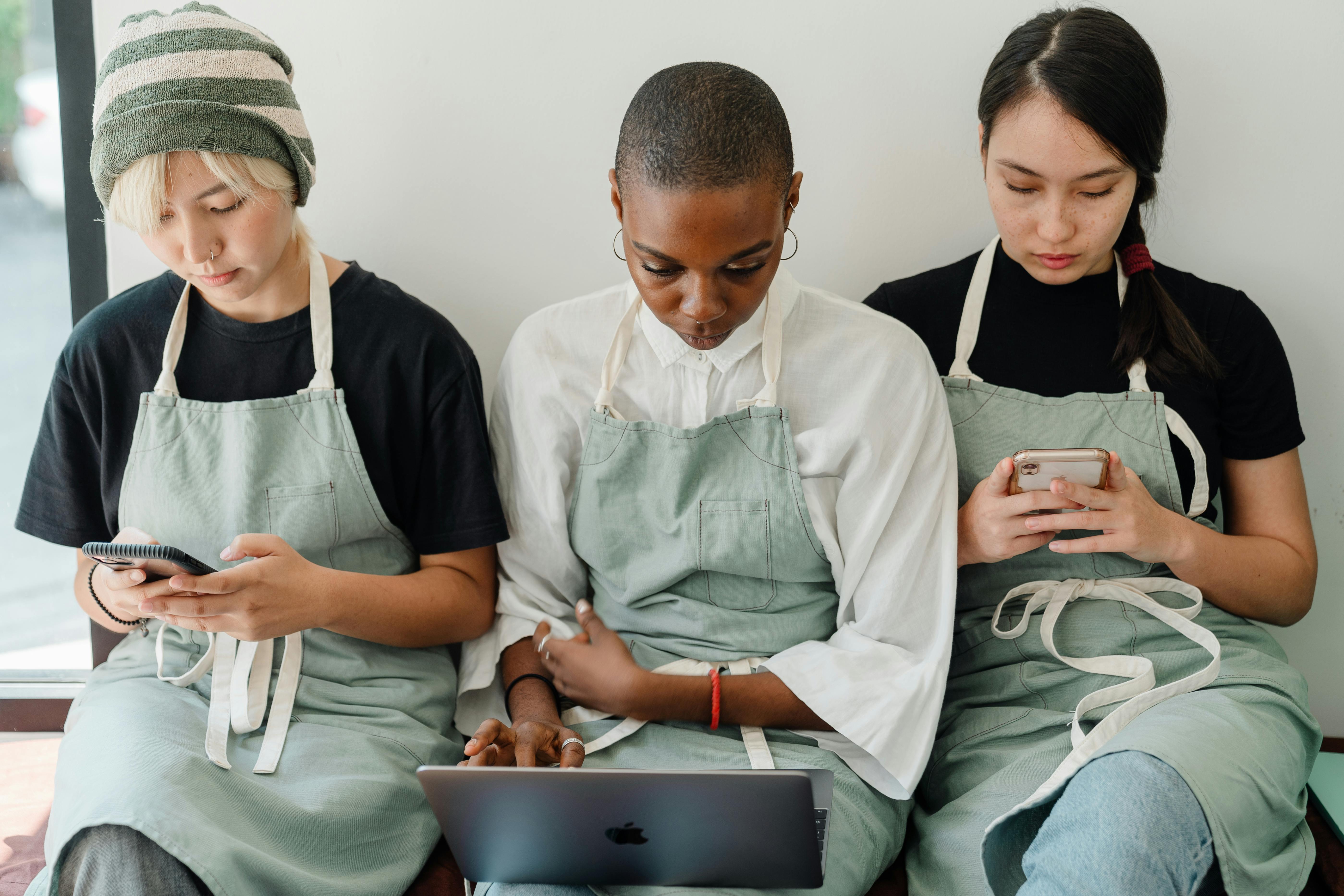 multiracial colleagues using gadgets at work