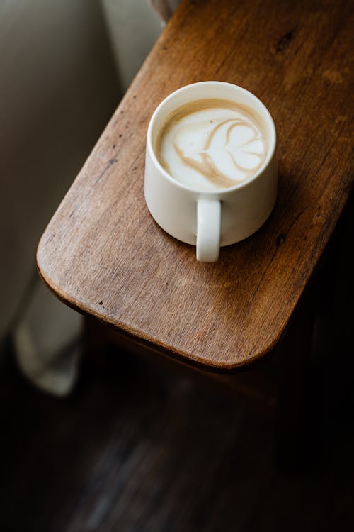 White Ceramic Mug on Brown Wooden Table