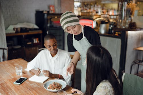 Cheerful diverse colleagues in modern cafeteria