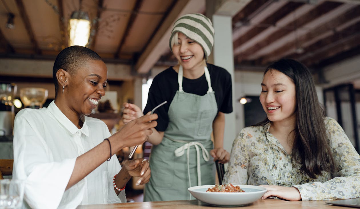 Free Delighted friends having lunch in cafe Stock Photo