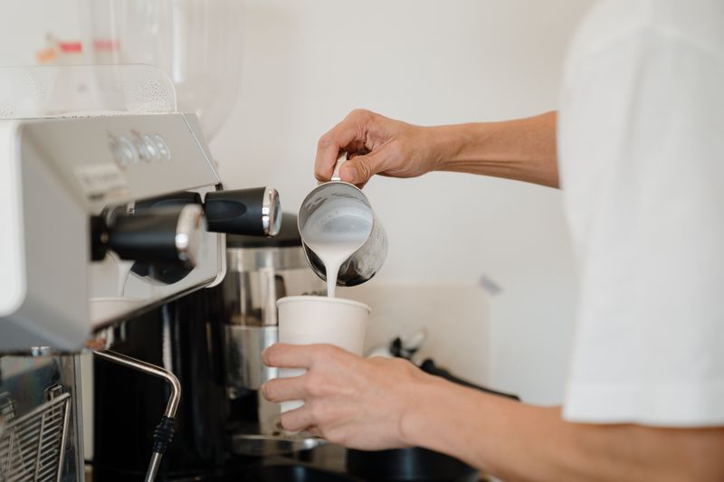 Grounded Coffee Co. barista pouring latte art in the Fitzroy cafe
