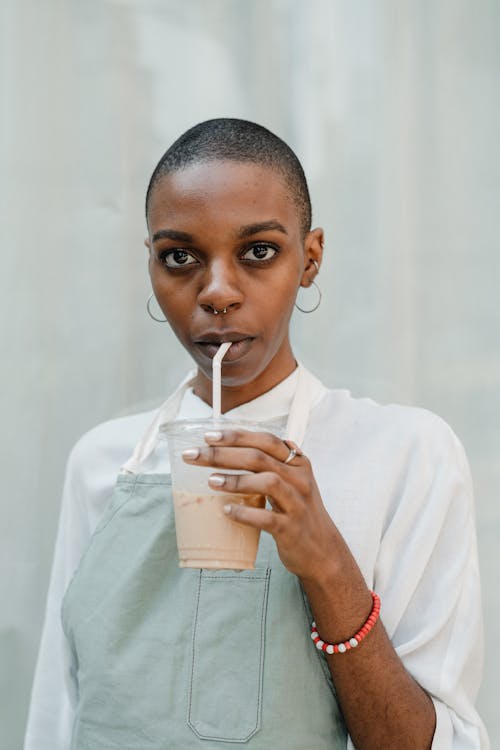 Free Photo of Woman Drinking Coffee From Disposable Cup Stock Photo