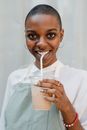 Photo of Woman Smiling While Holding Disposable Cup With Coffee