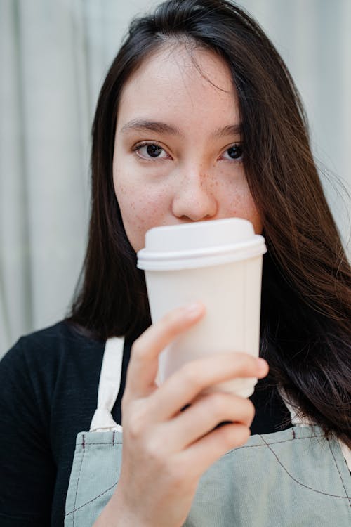 Photo of Woman Holding White Disposable Cup