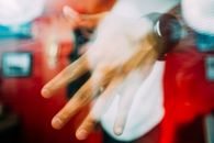 Hand of crop man in wristwatch behind glass