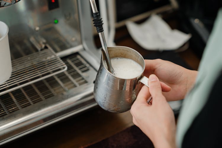 Crop Barista Whipping Milk In Stainless Steel Cup