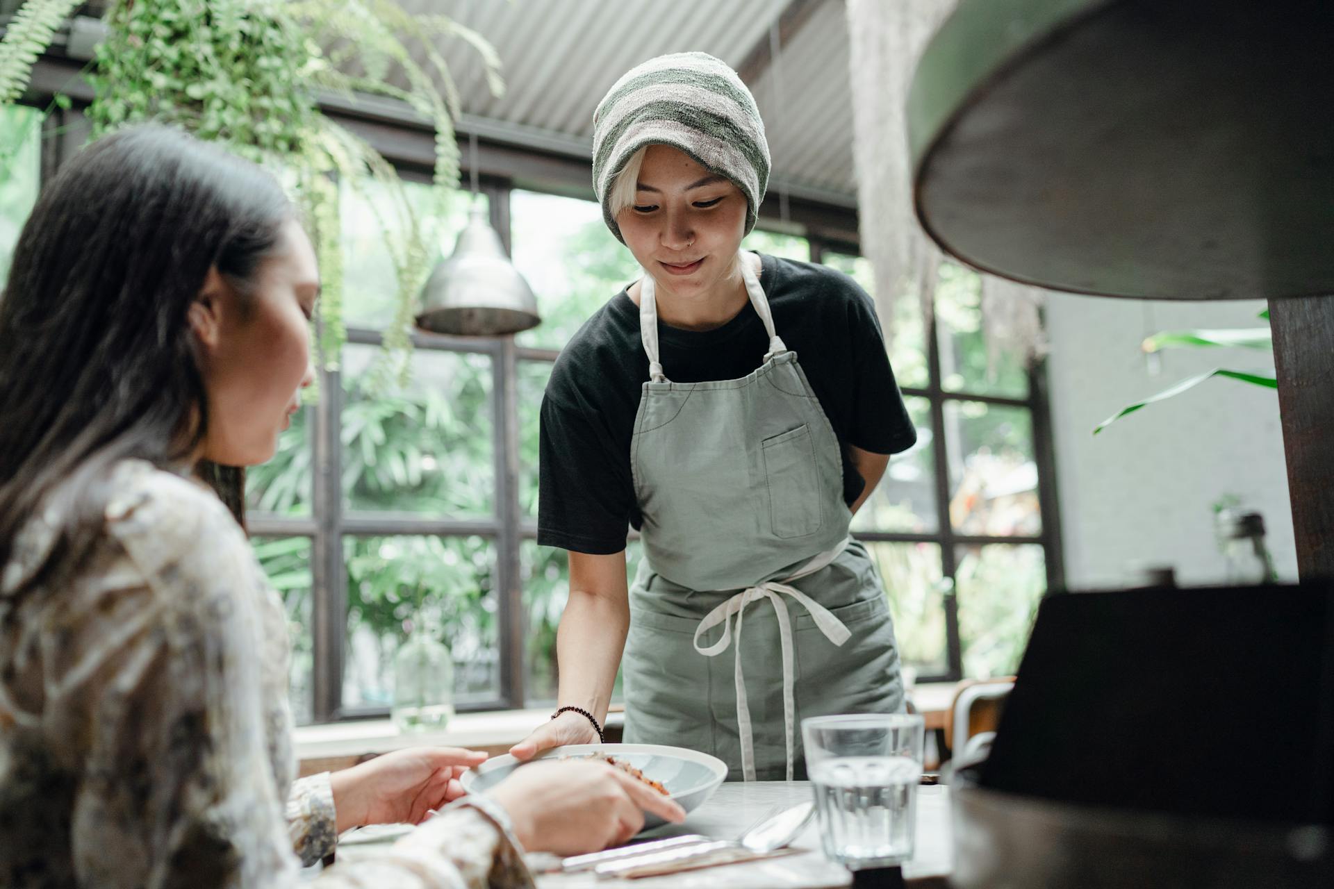 Smiling waitress serving food to customer