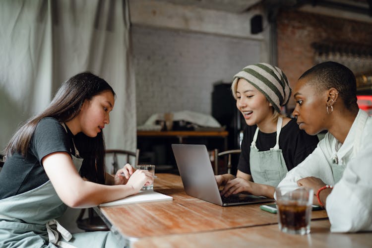 Happy Diverse Colleagues Working On Laptop