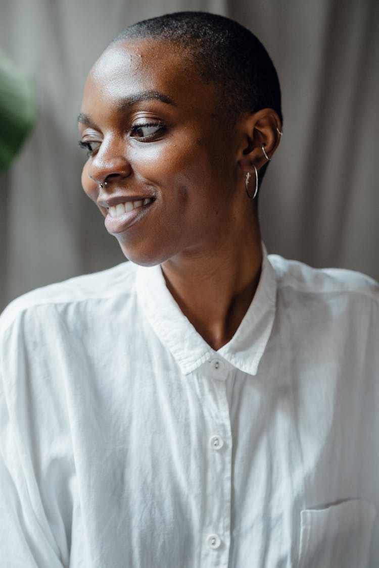 Cheerful Black Woman In White Blouse Looking Away