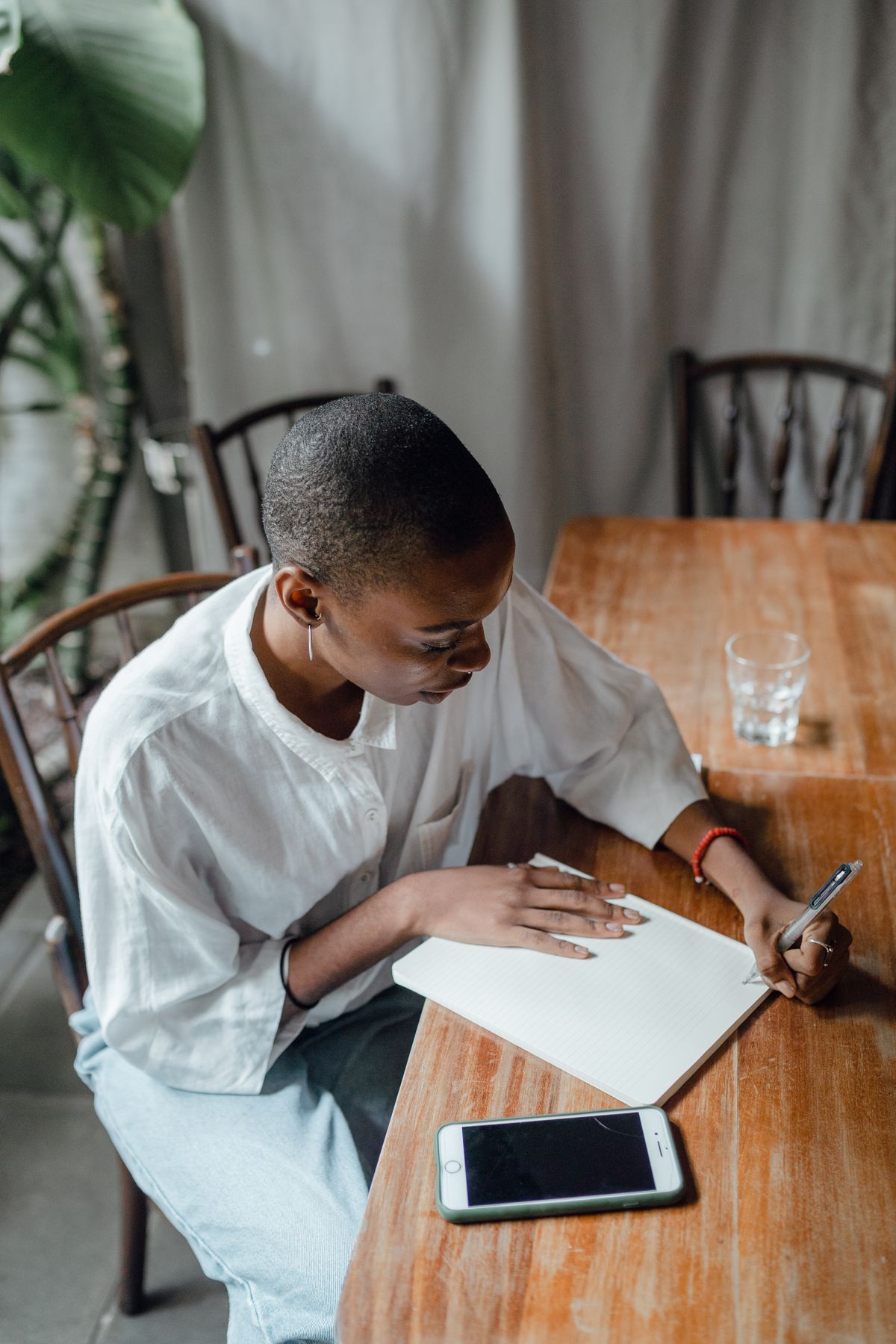 A woman writing notes in a notebook