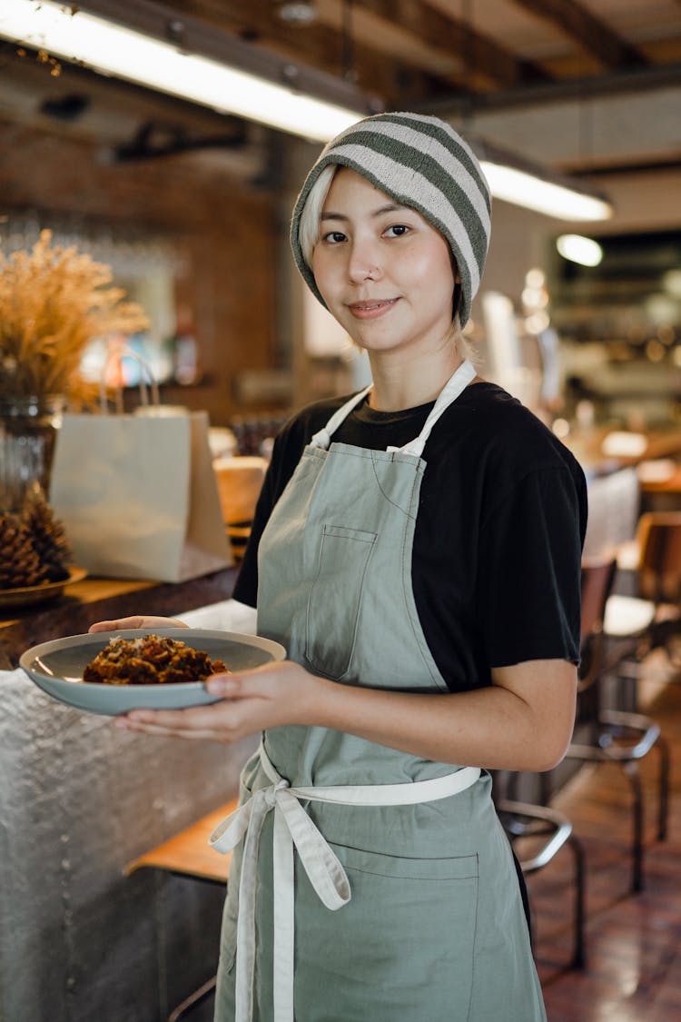 Positive Waitress Carrying Plate With Delicious Food