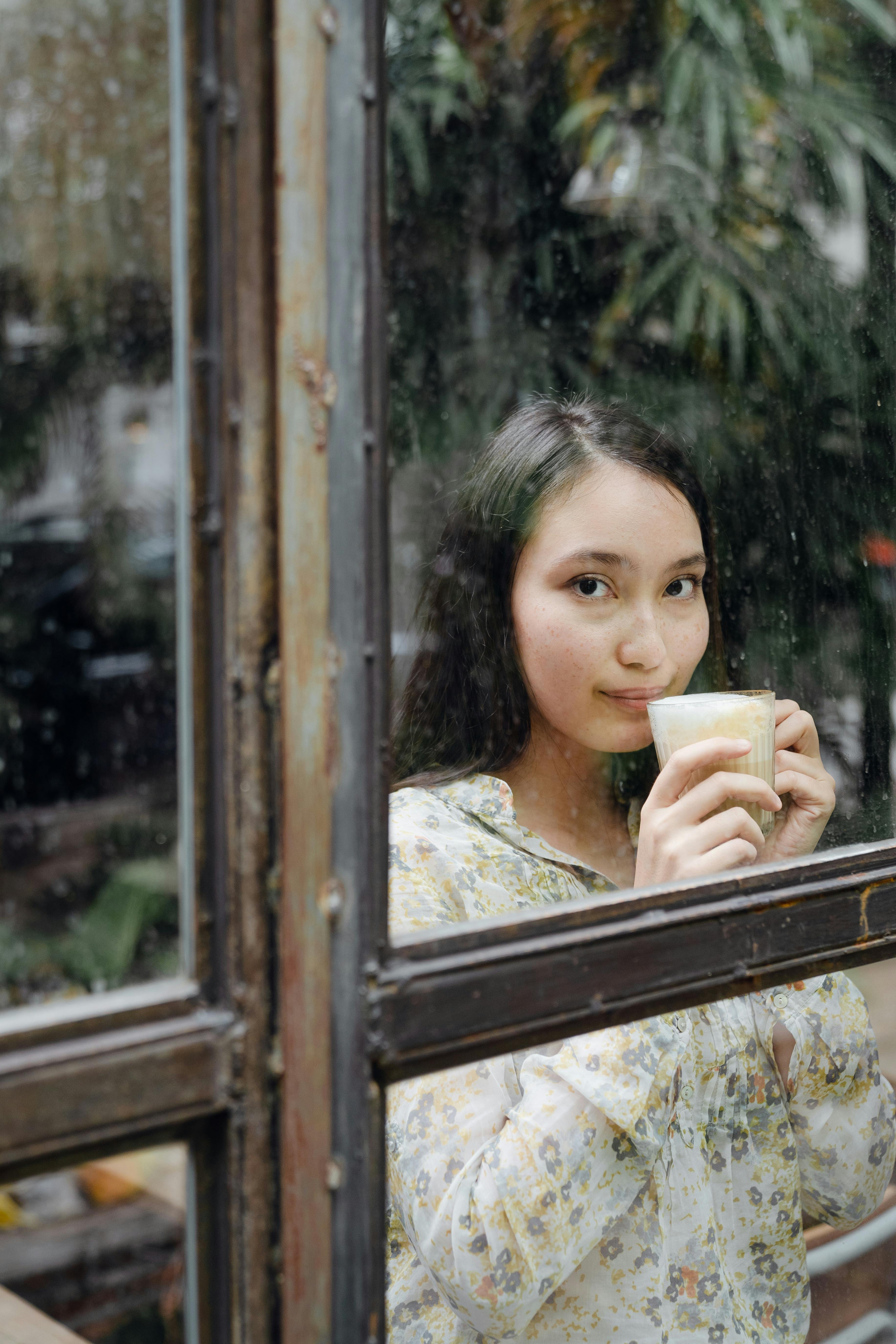 dreamy woman with cup of latte