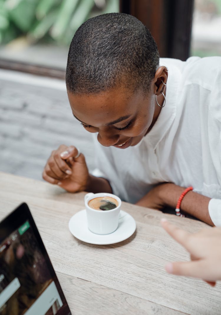 Young Black Woman Enjoying Coffee In Cafe