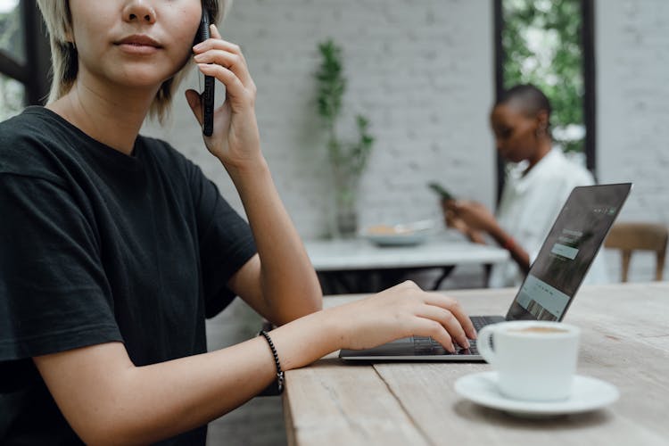 Person In Casual Wear Making Phone Call In Cafe