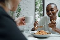 Couple of diverse friends eating and enjoying free time