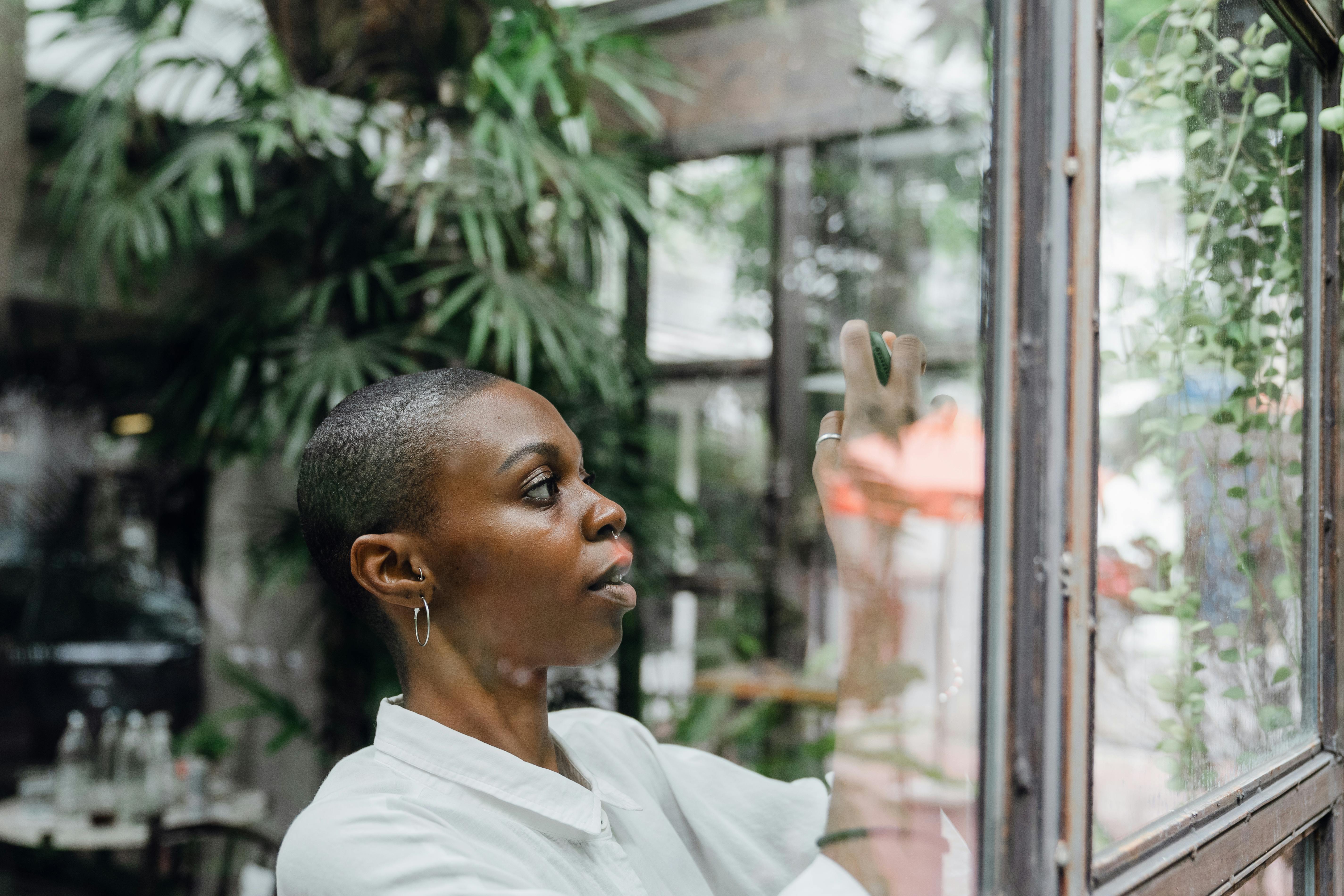 elegant black lady taking photo using smartphone in cafe