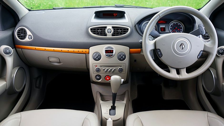 High-quality image of the Renault Clio interior showcasing the dashboard and steering wheel.